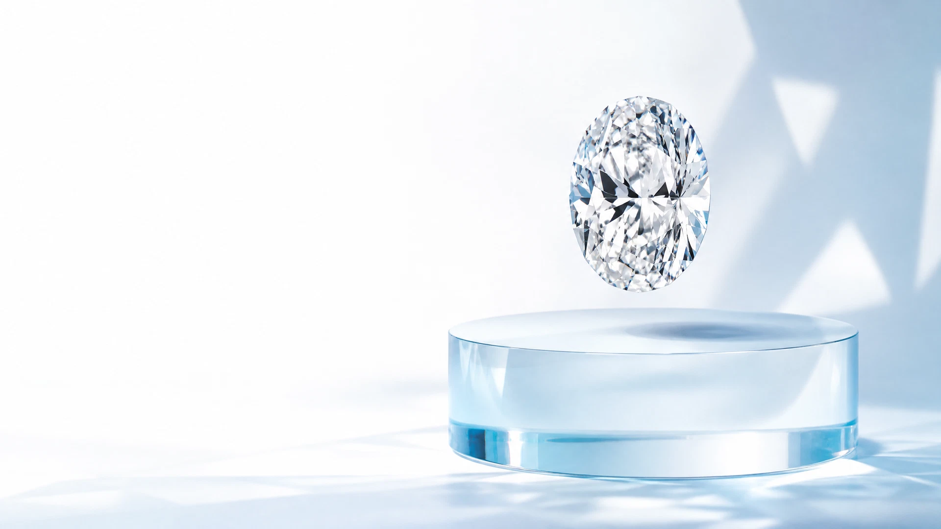 Oval lab-grown diamond above a blue glass plinth